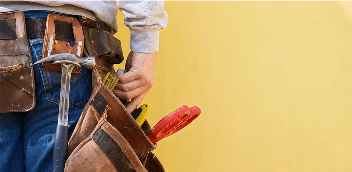 Handyman with tool belt ready for home repairs and maintenance in Colorado Springs, CO